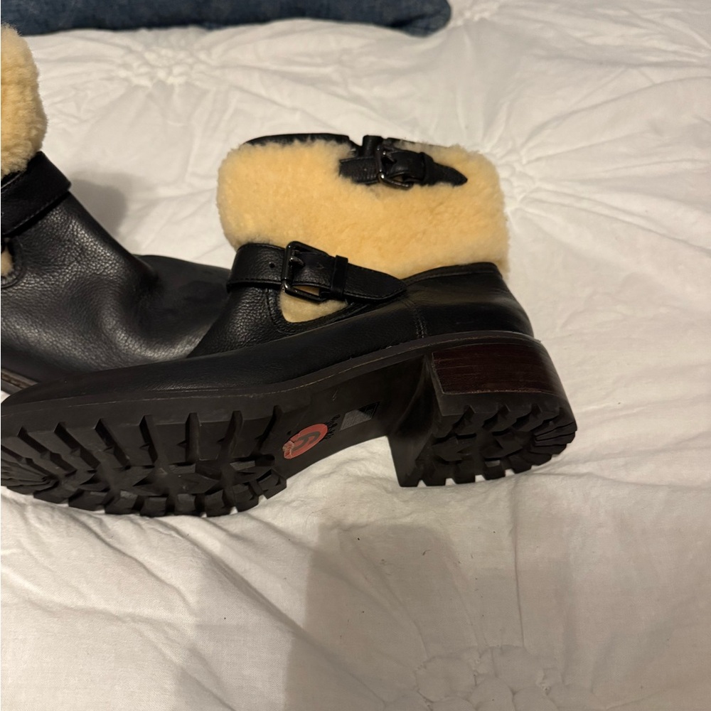 Coach black leather booties with adjustable buckle on side.